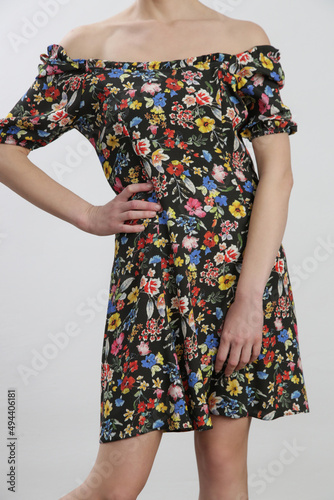 Studio shot of woman in floral summer dress.