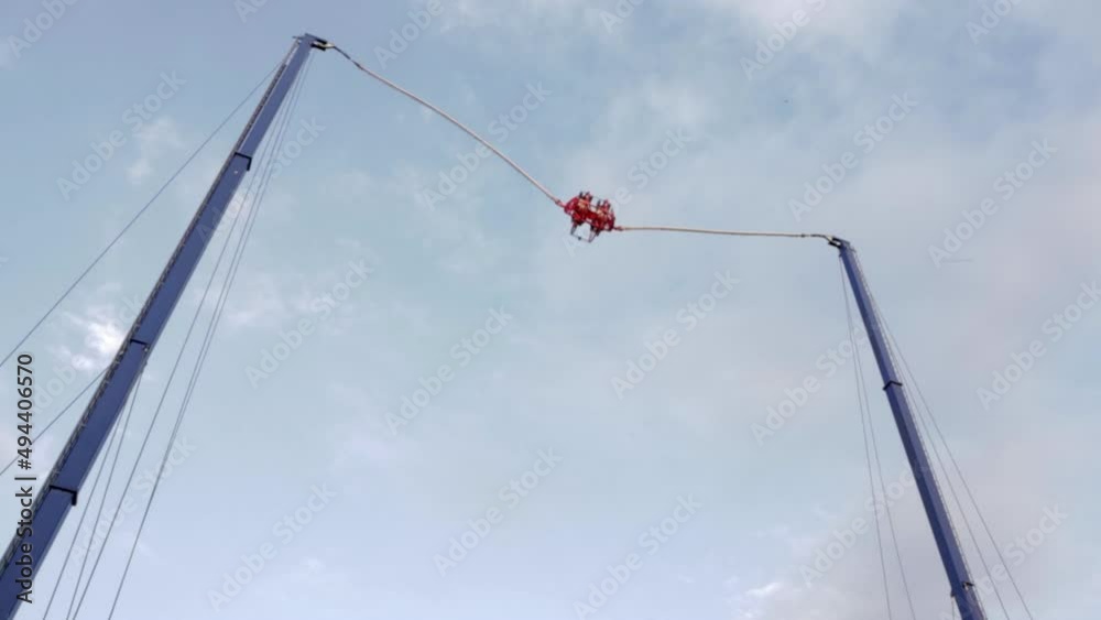 Extreme flying dangerous attraction. Jumping on rubber ropes. Extreme types of recreation and entertainment. A large catapult that shoots brave men. Extreme flying dangerous attraction. Jumping on rubber ropes. Extreme types of recreation and entertainment. A large catapult that shoots brave men.