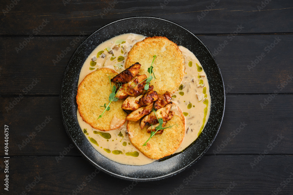 Overhead view of potato fritters with teriyaki chicken