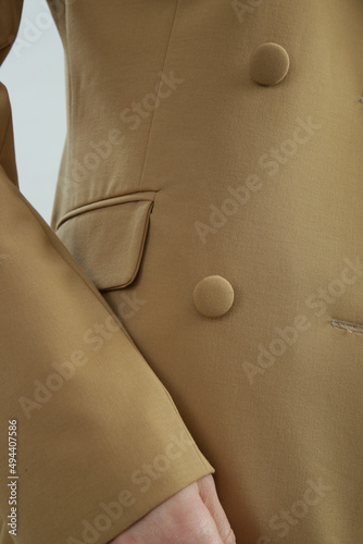 Close up image of beige tailored suit.
