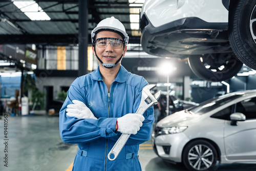Portrait of Asian handsome automotive mechanic men standing in garage.