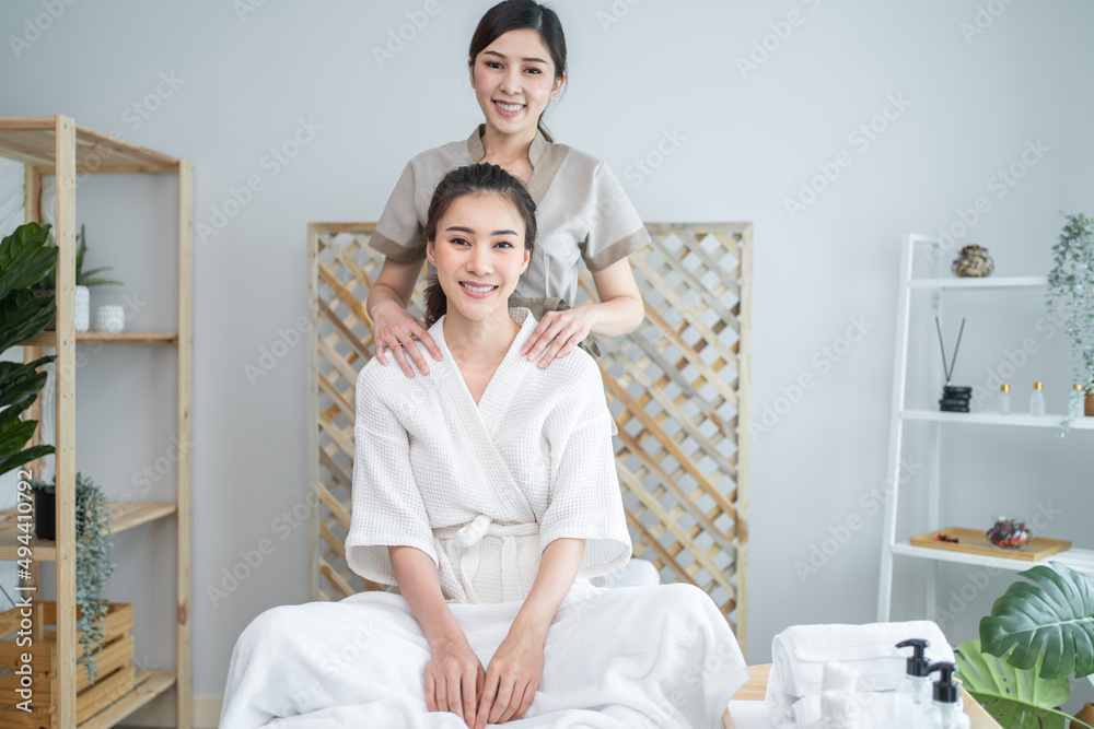Portrait of Asian happy woman feeling relax during and back massage.