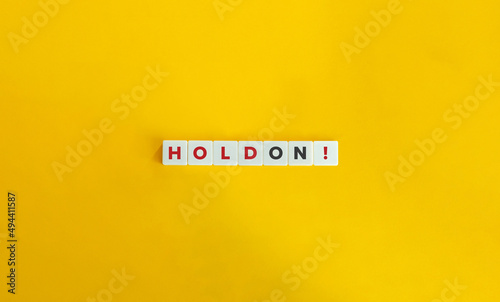 Hold On Phrasal Verb on Letter Tiles on Yellow Background. Minimal Aesthetics. photo