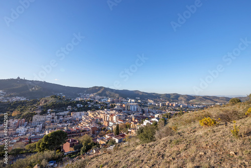 View of the city of Barcelona from the mountain on a sunny day. Urban landscape. Blue sky over the city. © Sergei