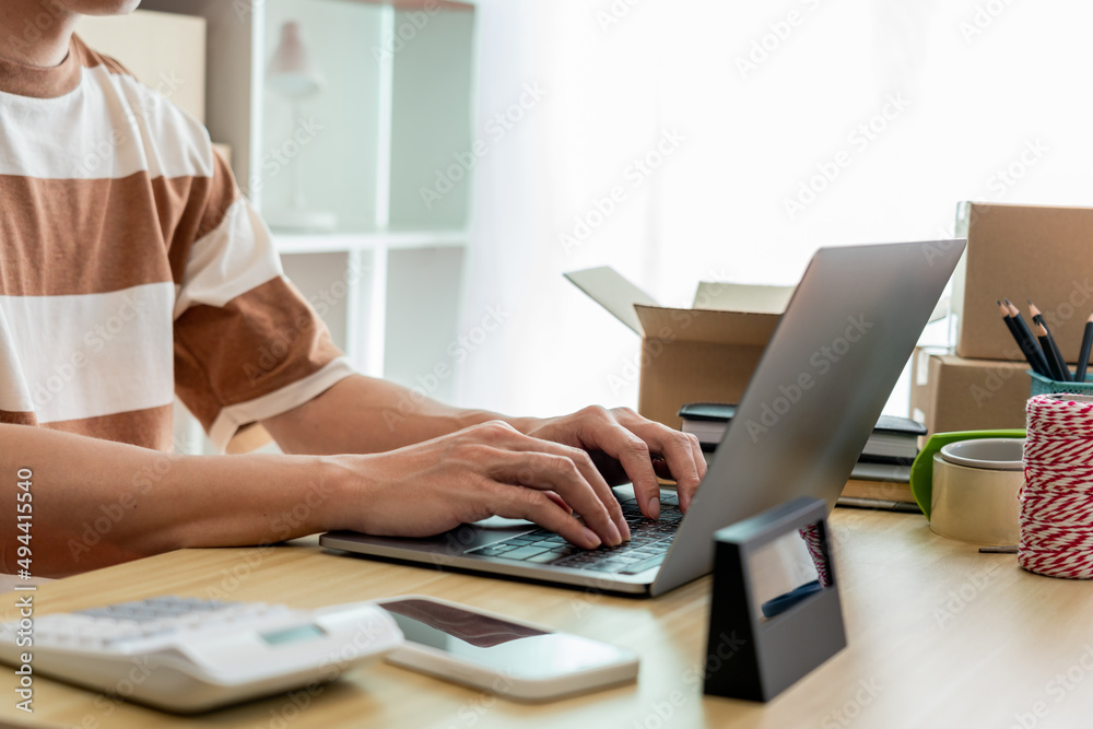 Online shopping concept an online seller typing on his laptop to fill the customer data Online shopping concept an online seller typing on his laptop to fill the customer data