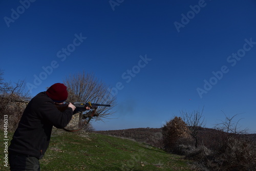 A man shooting skeet with a shotgun 