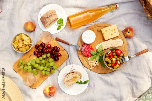 leisure and eating concept - close up of food and drinks on picnic blanket