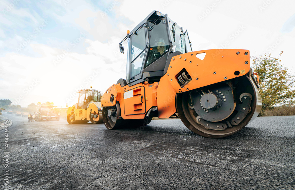 Vibratory asphalt rollers compactor compacting new asphalt pavement. Road service repairs the highway	
