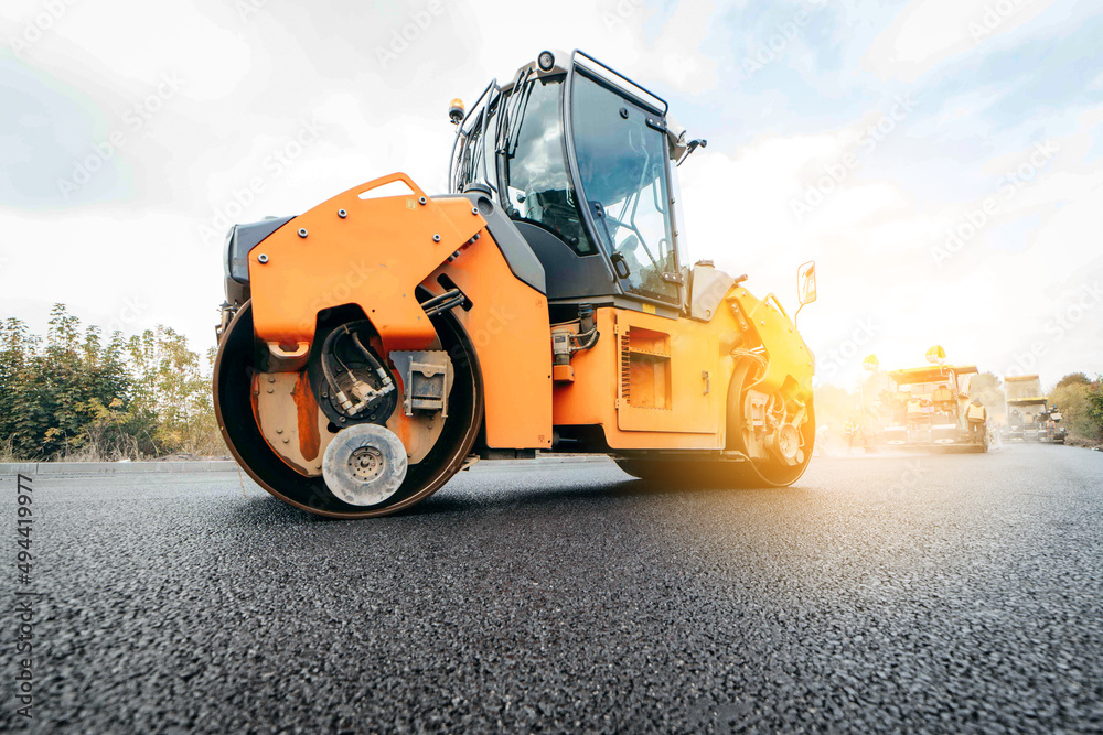 Vibratory asphalt rollers compactor compacting new asphalt pavement. Road service repairs the highway	
