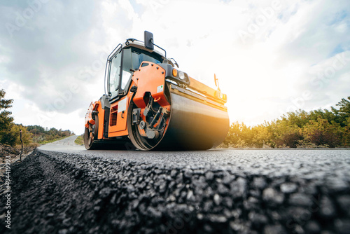 Vibratory asphalt rollers compactor compacting new asphalt pavement. Road service repairs the highway	
