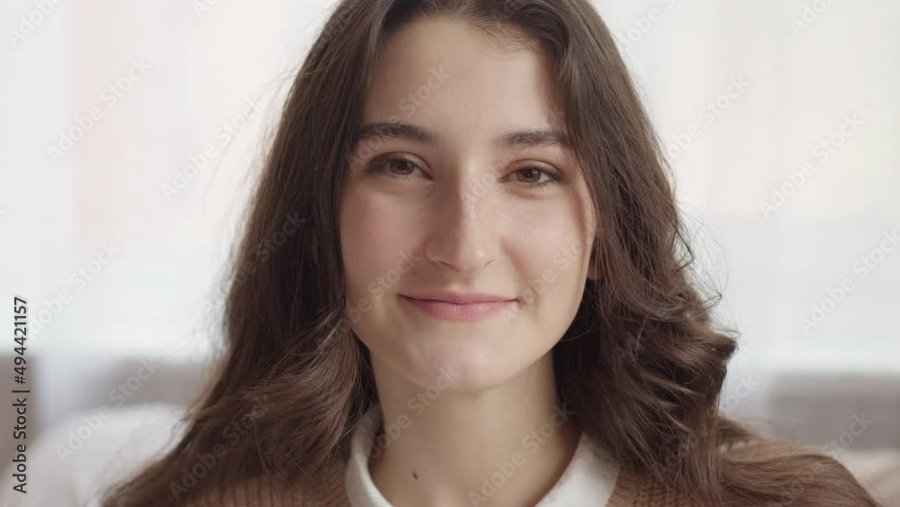 Face of a smiling young beautiful woman. Close-up. Portrait of a happy brunette girl. Face of a smiling young beautiful woman. Close-up. Portrait of a happy brunette girl.