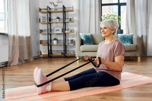 Obraz na płótnie sport, fitness and healthy lifestyle concept - smiling senior woman exercising w