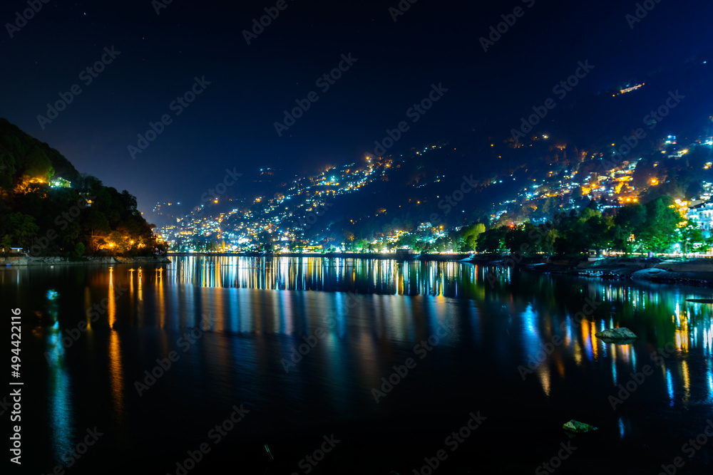 Nightscape of Nainital city with city light reflection on Naini Lake in Uttrakhand, India
