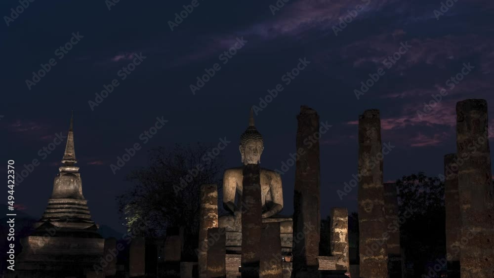 Buddha statue and pagoda ancient at Sukhothai Historical Park, Sukhothai, Thailand. Time Lapse cloudy or Overcast day. Buddha statue and pagoda ancient at Sukhothai Historical Park, Sukhothai, Thailand. Time Lapse cloudy or Overcast day.