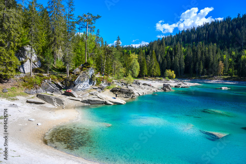 Paradise beach in bay of Cauma Lake (Caumasee) with crystal blue water in beautiful mountain landscape scenery at Flims, Graubuenden - Switzerland