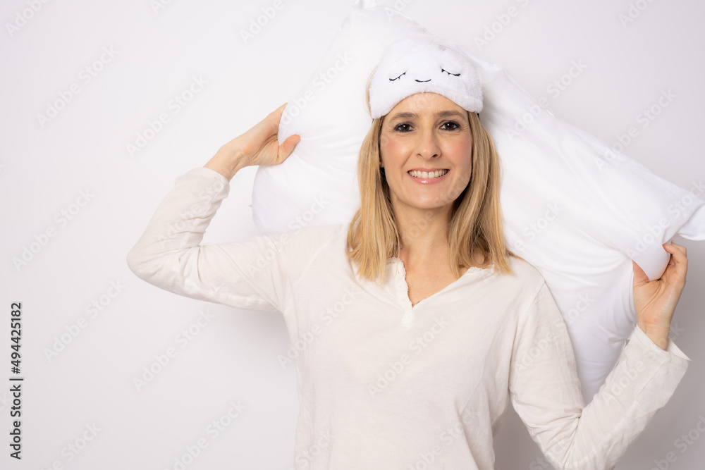 Young woman in nightwear smiling and embracing soft pillow after good night sleep isolated over white background Young woman in nightwear smiling and embracing soft pillow after good night sleep isolated over white background