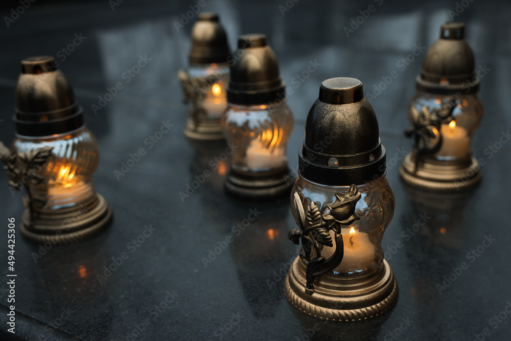 Grave lights on granite surface at cemetery Grave lights on granite surface at cemetery