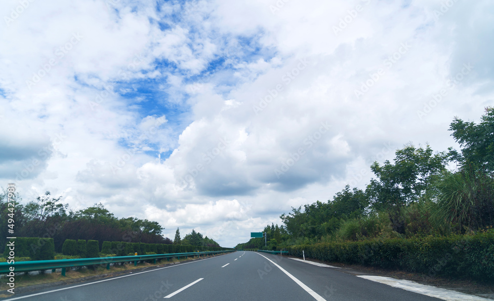 Fototapeta premium Asphalt expressway on a summer day with clouds