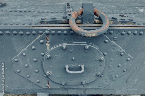 Obraz na plátně gray riveted heavy metal plates with a rusty iron ring of a sluice gate