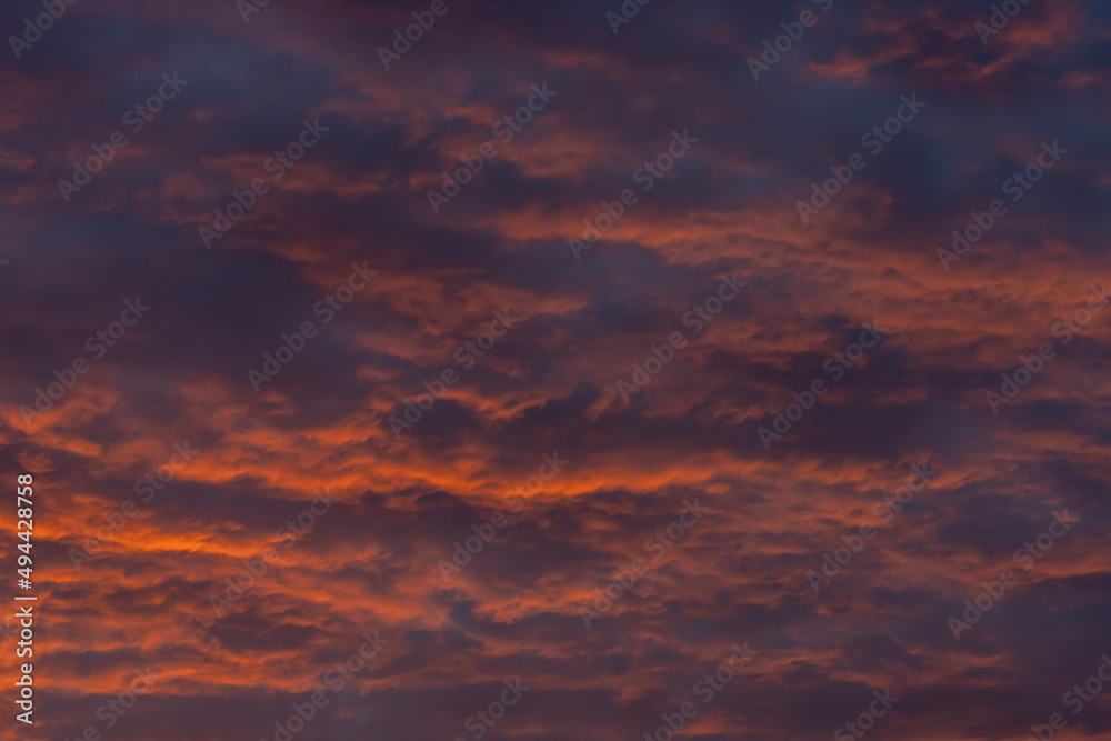 Colorful clouds in the rays of the setting sun