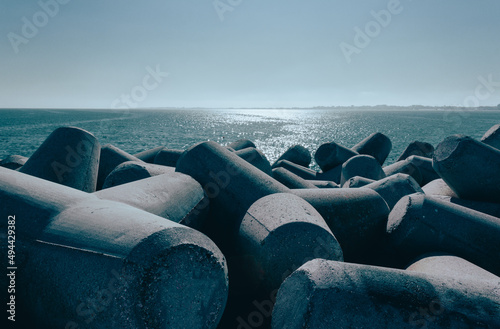 View from the Diga Sottomarina pier. Concrete breakwater with the blue sea background meeting the horizon. Seascape. photo