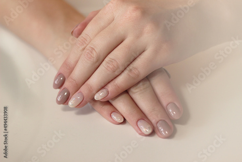  close-up tenderness neutral beige manicure with glitter two hands