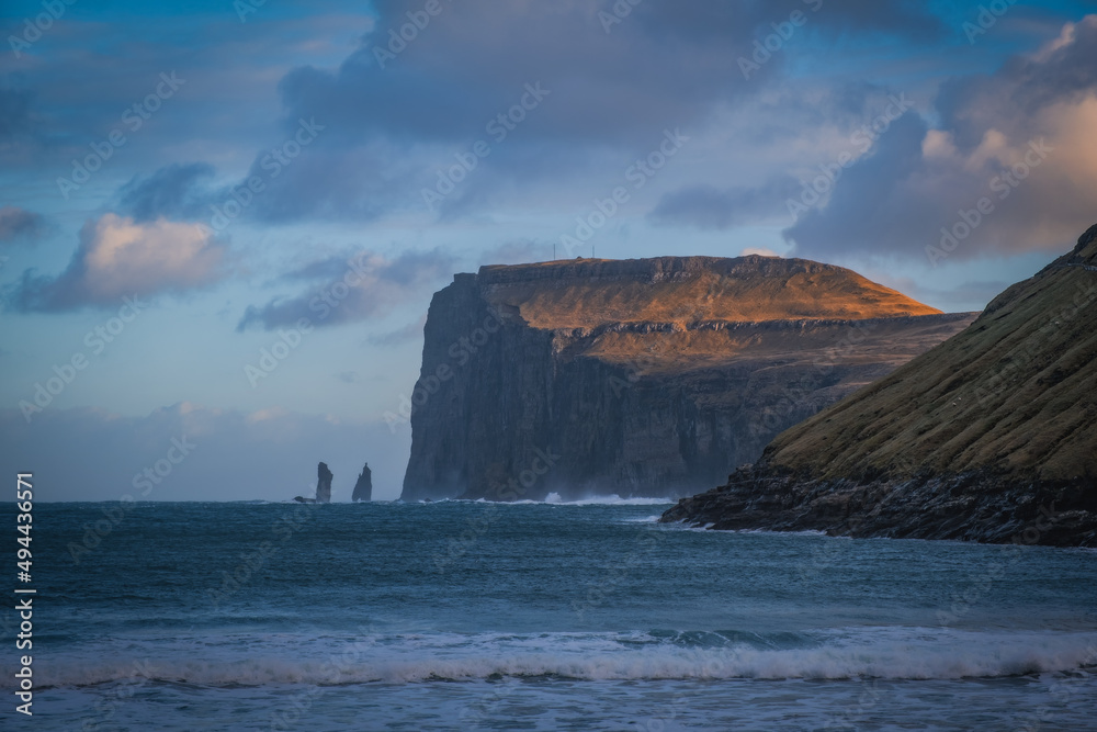 Picturesque landscape with spectacular view to village Tjornuvik Tjornevig on Island Streymoy of the Faroe islands. View to legendary sea stacks Risin og Kellingin.The Giant and the Witch. November 21