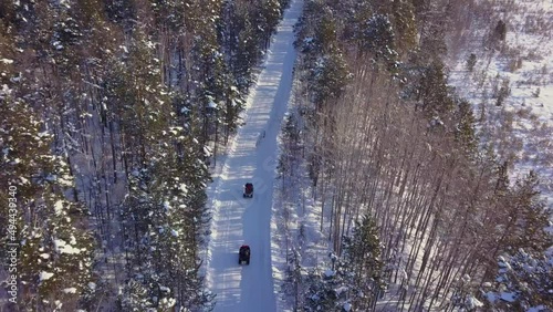 An expedition of atv riders travels along Lake Baikal. Shooting from a drone photo