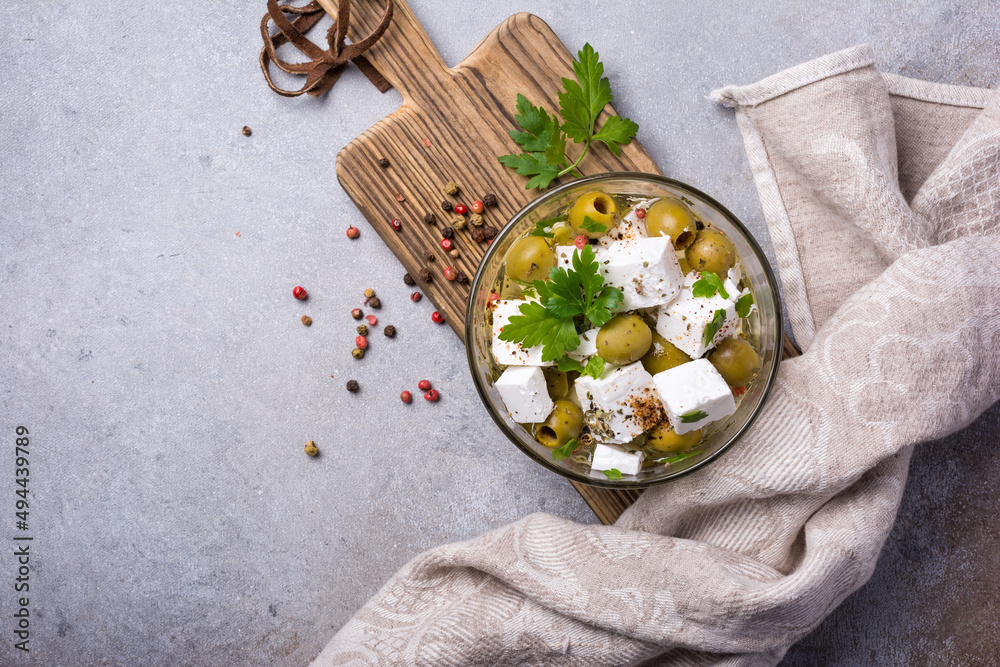 Bowl of delicious olives with Feta cheese in oil Bowl of delicious olives with Feta cheese in oil