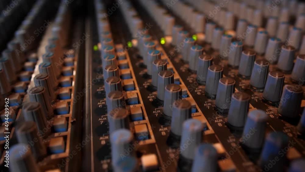 Macro slide shot of a music mixer with editing tools in a professional recording studio.