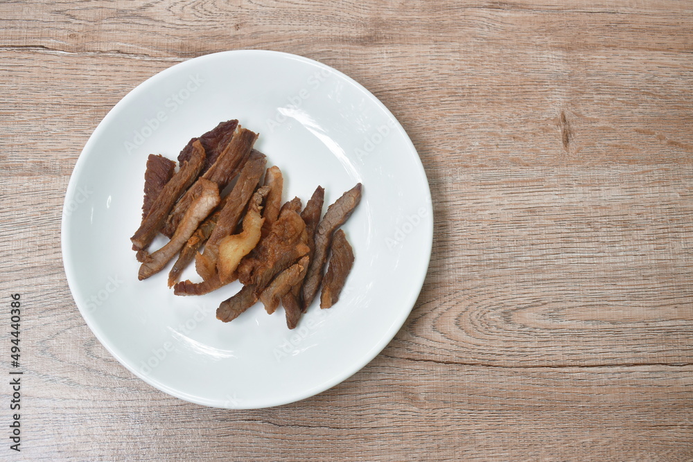 crispy fried salty beef meat and belly arranging on plate crispy fried salty beef meat and belly arranging on plate