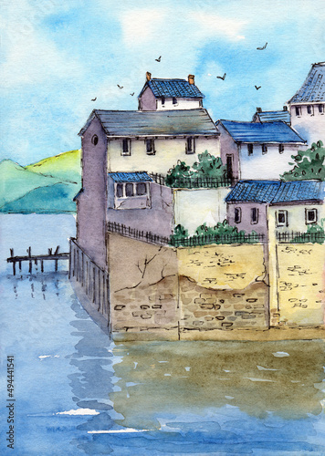 Watercolor illustration of a small town above the sea with blue roofed houses, trees growing behind a hedge and a wooden jetty near a stone wall