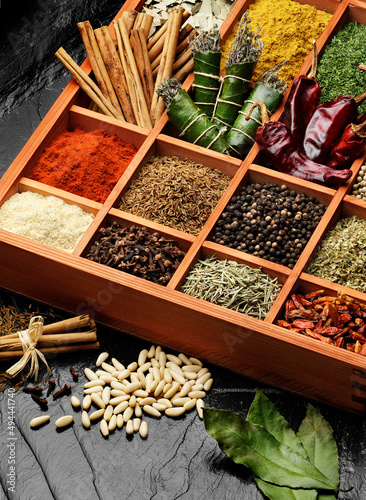 assorted spices and herbs in wooden box photo