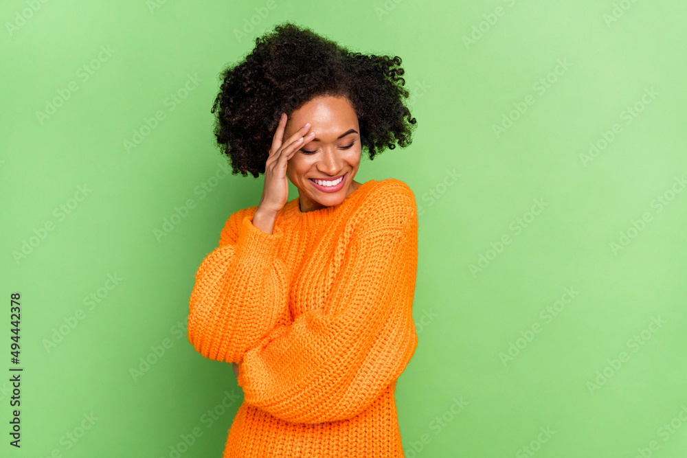 Photo of sweet millennial volume hairdo lady close face wear orange jumper isolated on green color background Photo of sweet millennial volume hairdo lady close face wear orange jumper isolated on green color background