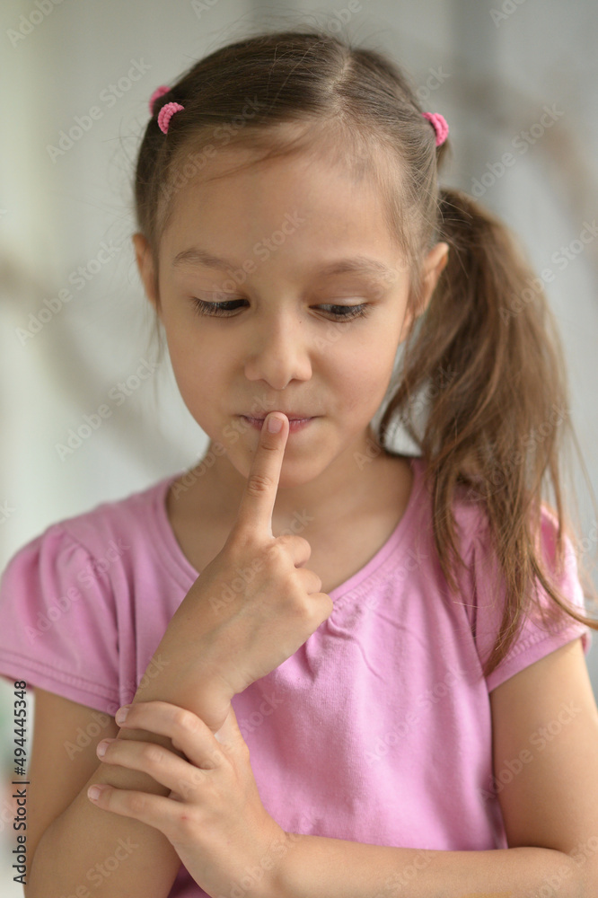 cute little girl with silence gesture at home cute little girl with silence gesture at home