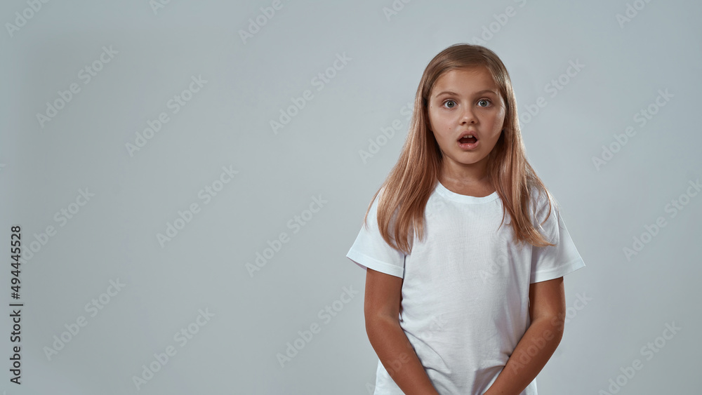 Partial of shocked little girl with open mouth