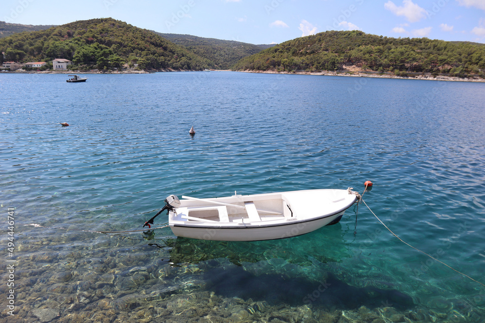 Seascape, white boat in a picturesque bay on the sea coast, Povlija, Croatia