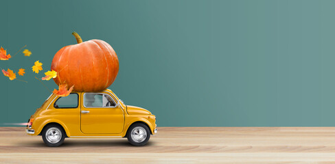 Thanksgiving is coming. Yellow car is carrying a pumpkin