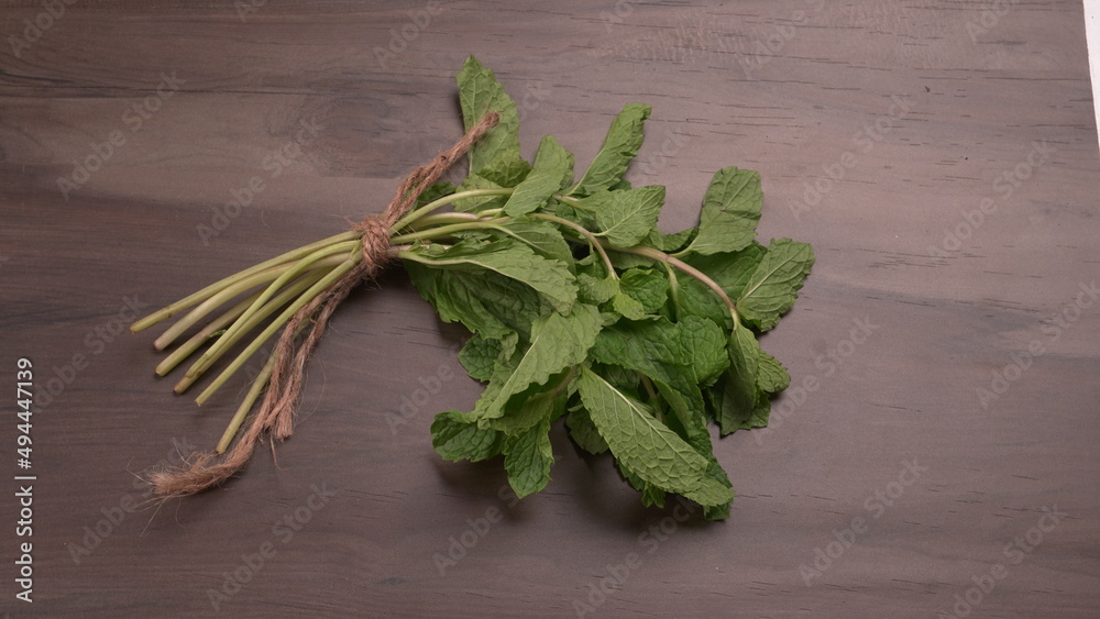 Bundle of fresh spinach isolated on wooden background. Vegan food lifestyle concept, Copy space. Bundle of fresh spinach isolated on wooden background. Vegan food lifestyle concept, Copy space.