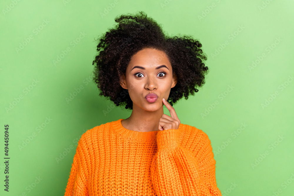 Photo of flirty millennial volume hairdo lady blow kiss wear orange pullover isolated on green color background Photo of flirty millennial volume hairdo lady blow kiss wear orange pullover isolated on green color background