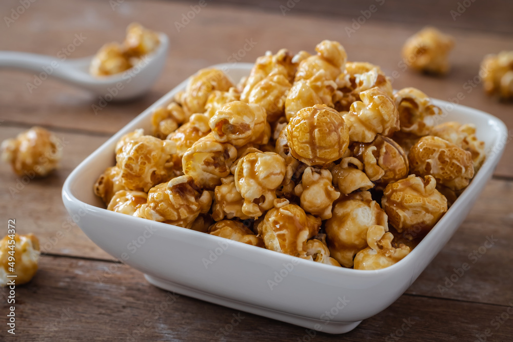Popcorn with caramel in white bowl Popcorn with caramel in white bowl