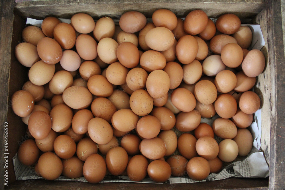 A box of chicken eggs in a wooden box A box of chicken eggs in a wooden box