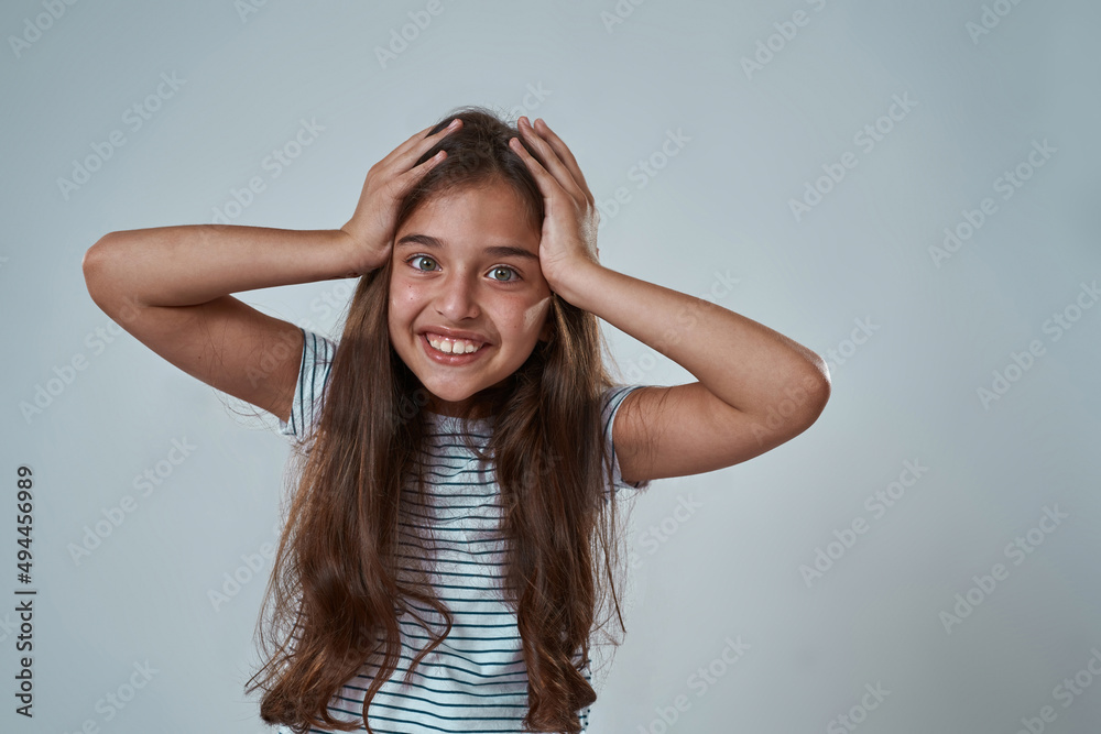 Partial image of little girl touching her head Partial image of little girl touching her head