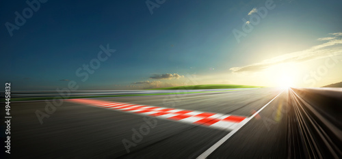 Evening scene asphalt international race track with starting or end line, digital imaging recomposition background. © Image Craft