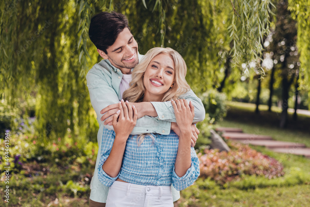Portrait of two attractive cheerful sweet couple hugging spending time daydream honey moon on fresh air outdoors