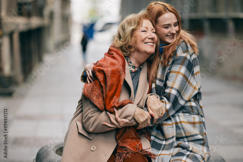 Konstfotografi A happy grandmother and granddaughter hugs outside.