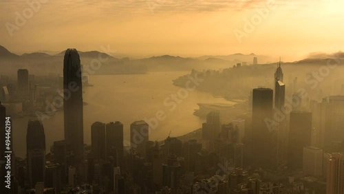 Time lapse of skyscraper in downtown district of Hong Kong city in fog under sunrise