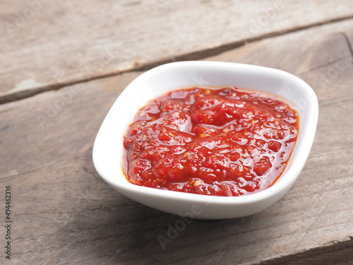 Very spicy chili sauce in a white bowl