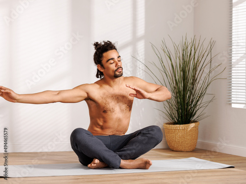 Calm African American man meditating in morning