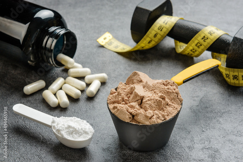 Scoops with protein and creatine close-up. The concept of sports nutrition and supplements.
